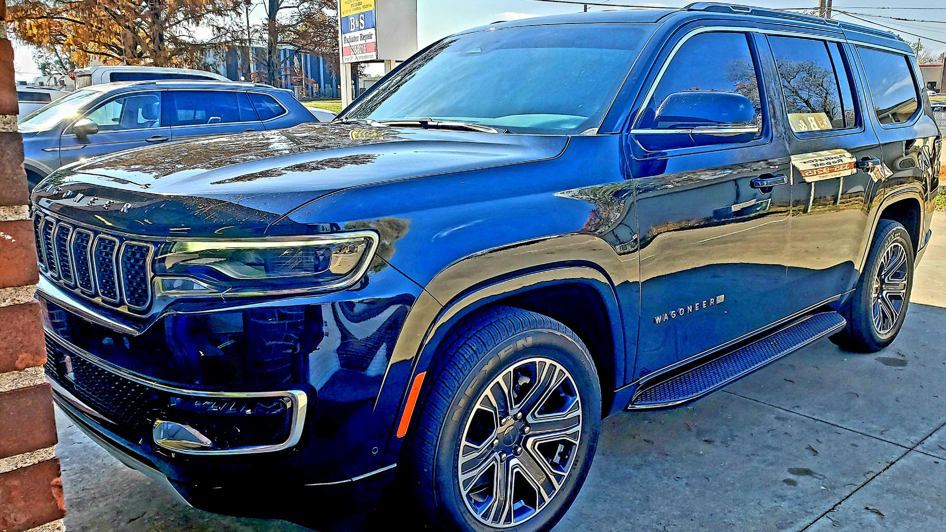 Blue Jeep Grand Wagoneer with dark tint