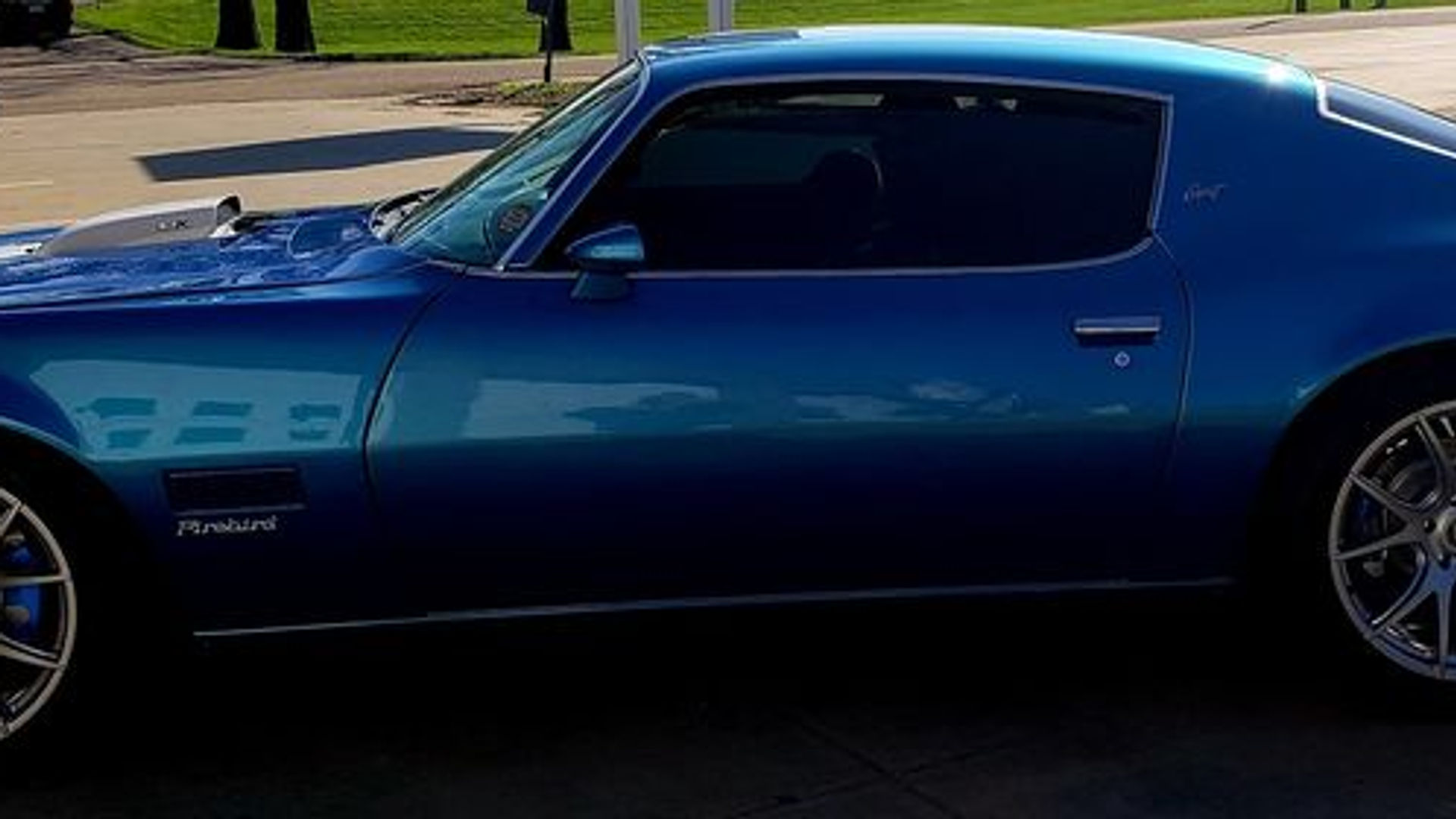 Blue Pontiac Firebird with tinted windows
